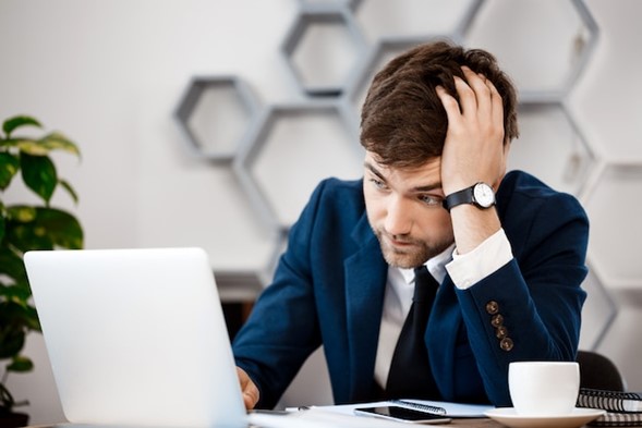 Man Sadly Looking Into his Computer