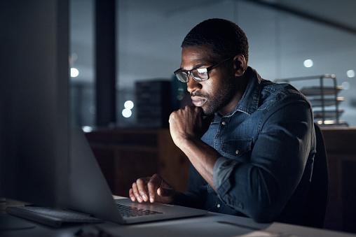 Man Sitting in front of Laptop